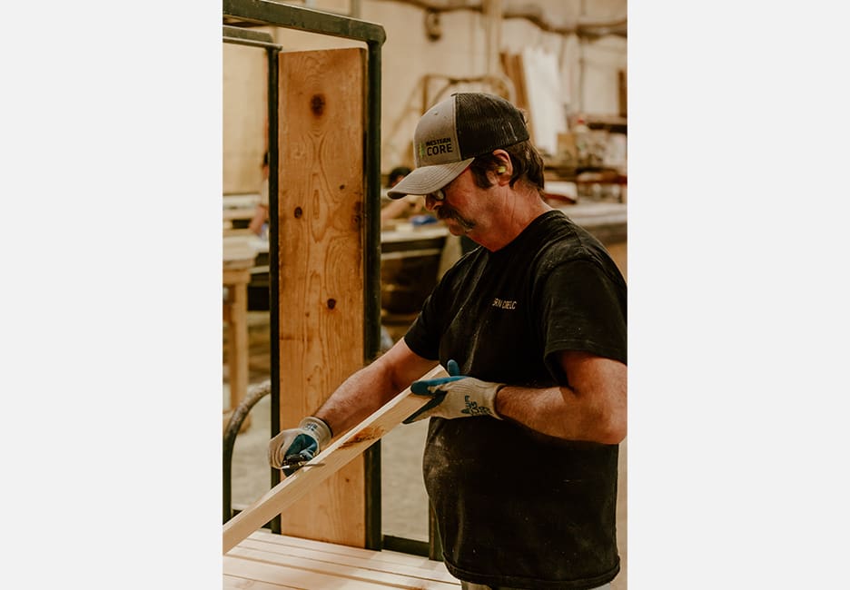 A man holding a wooden stick in his hands.